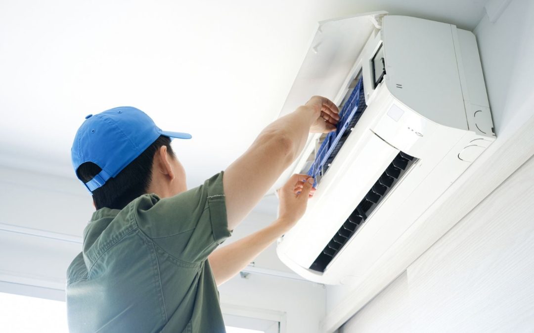 Air conditioning technician maintaining an indoor mini split system in Littleton, CO
