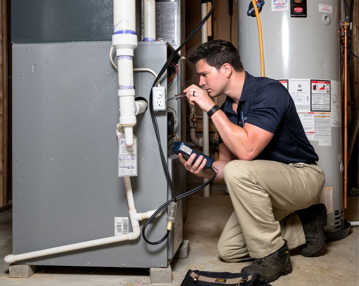 HVAC technician performing a furnace tune-up in Littleton