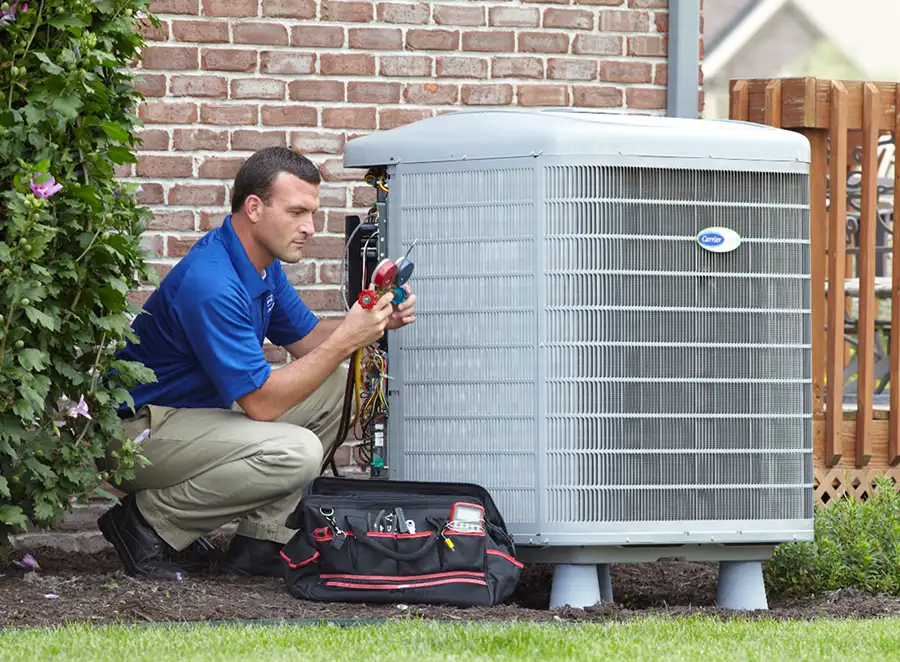 HVAC technician inspecting an outdoor air conditioning unit in Littleton